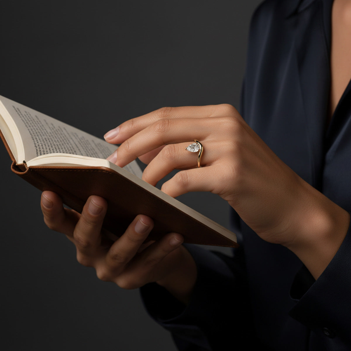 LUMEO Pear Diamond Trace Ring Front View in 18k Solid Yellow Gold on model