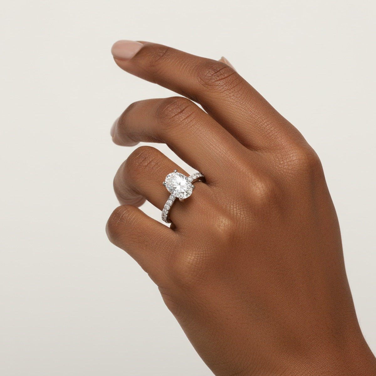 LUMEO Oval Classic Solitaire Diamond Engagement Ring with Diamond Band on model in Platinum or 18k Solid White Gold